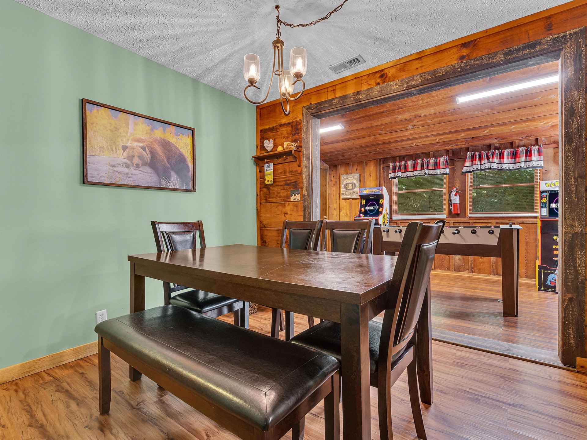 Gather around this warm dining space where rustic wood beams and cozy lighting create the perfect setting for memorable meals together.