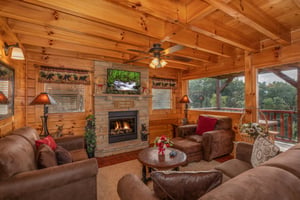 Fireplace and TV in the living room at 1 Above the Smokies, a 2 bedroom cabin rental located in Pigeon Forge