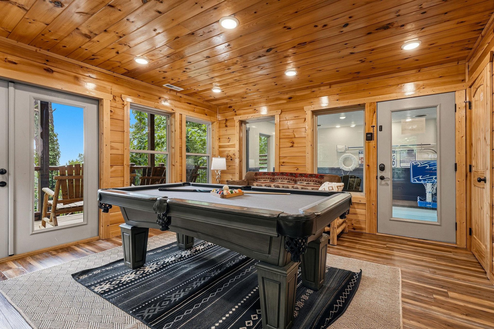 Challenge friends to a game of pool in your private game room, where warm wood tones and natural light create the perfect atmosphere for fun and relaxation.