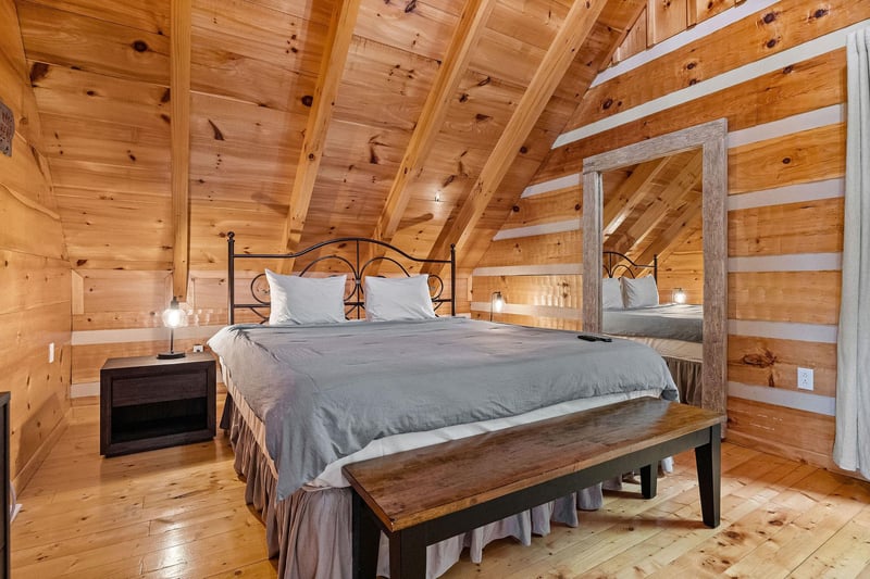 King bed beside full length mirror