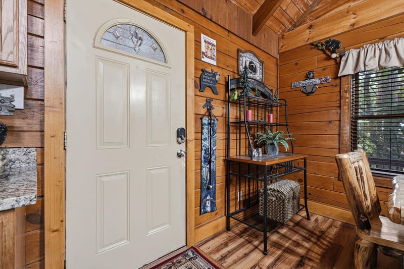 Warm wood beams and walls welcome you into your cozy cabin retreat, where rustic charm meets inviting comfort from the moment you step inside.