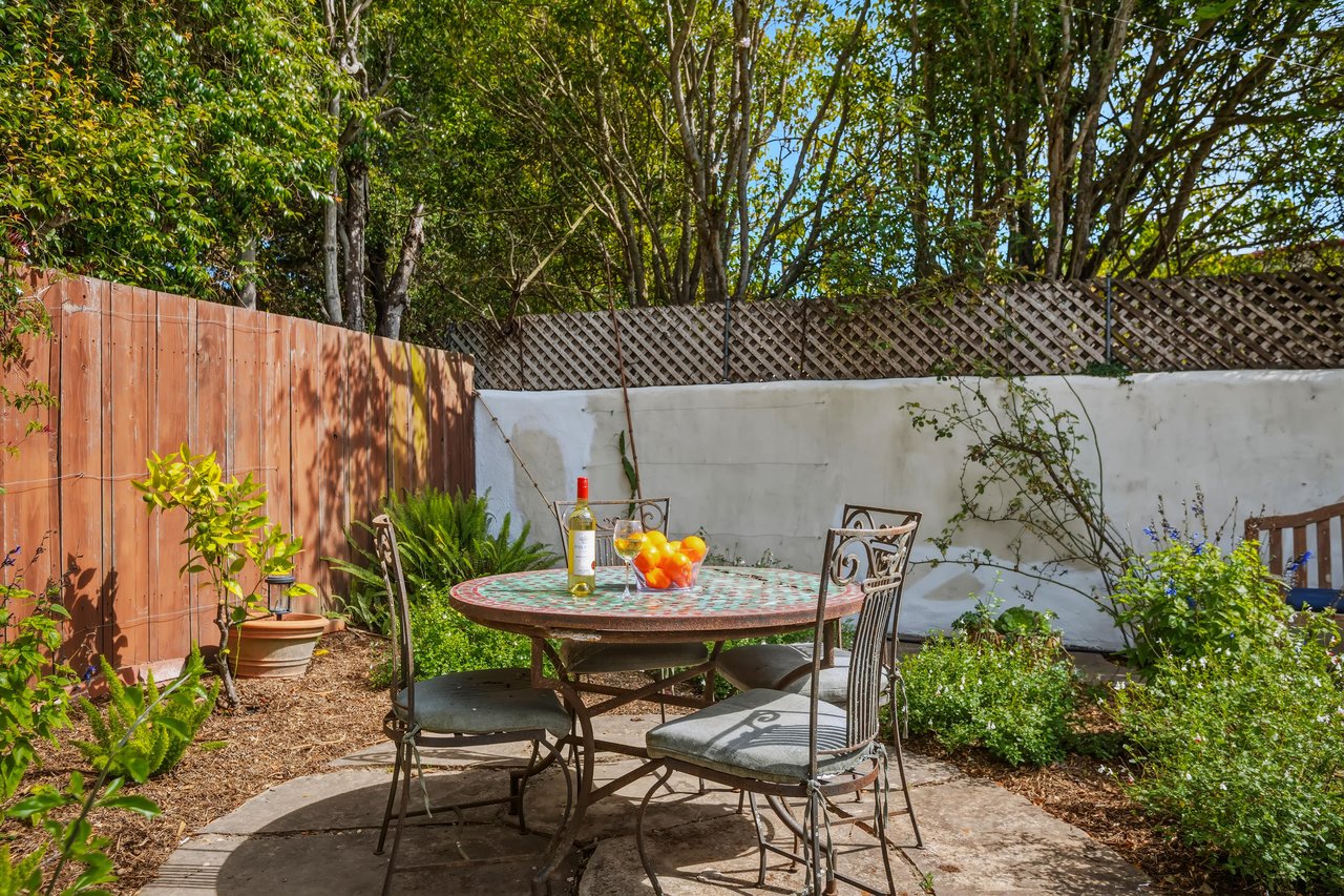 Stunning patio with mosaic tiles, outdoor seating, and an outdoor shower.