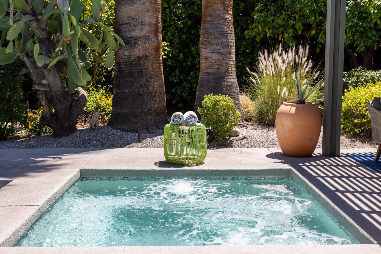 Entertainers backyard with outdoor seating, private pool and spa, sun loungers, cabana, and outdoor dining space.