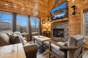 Cozy up in your rustic living room with a crackling fireplace and stunning mountain views through panoramic windows.