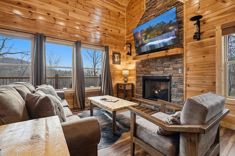 Cozy up in your rustic living room with a crackling fireplace and stunning mountain views through panoramic windows.