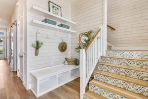 Foyer with Storage and Accented Stairwell