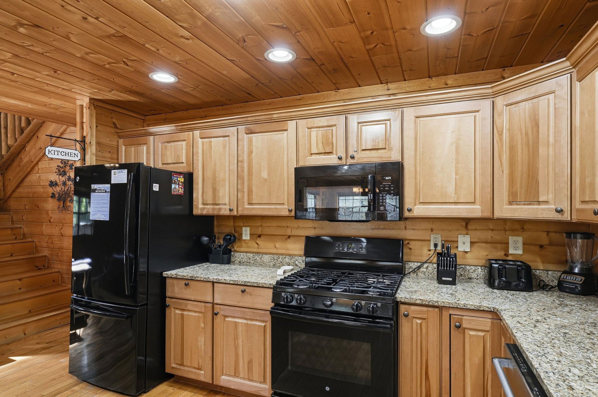 Your cabin kitchen features warm wood cabinetry, granite countertops, and fullsize appliances for preparing memorable mountain meals together.