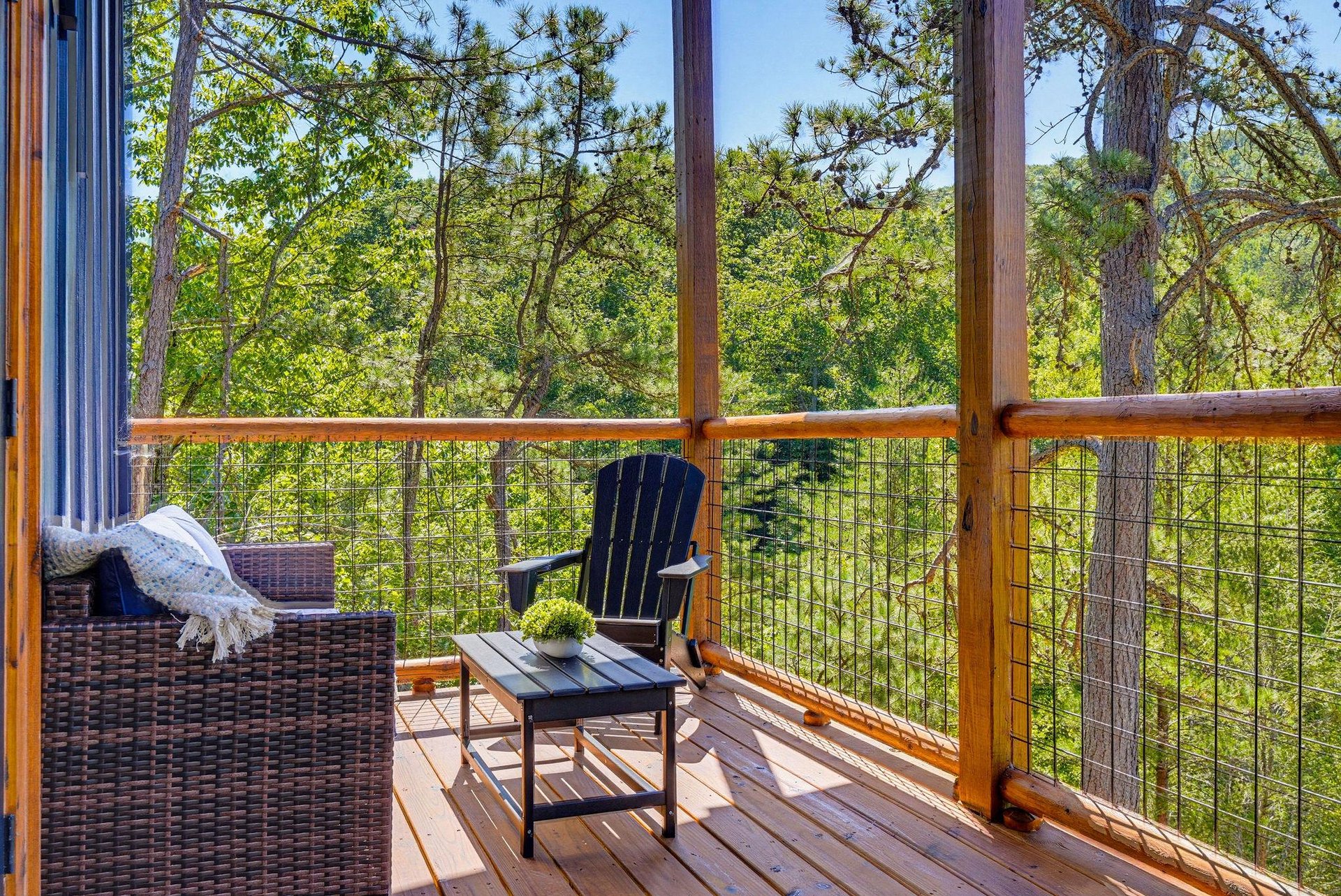 Picture yourself relaxing on this private deck surrounded by towering pines. Sink into the cozy outdoor seating with a warm throw, breathe in the fresh forest air, and let the peaceful treetop views m