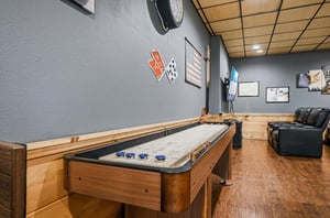 Your private game room awaits with air hockey thrills and cozy leather seating for postgame relaxation.