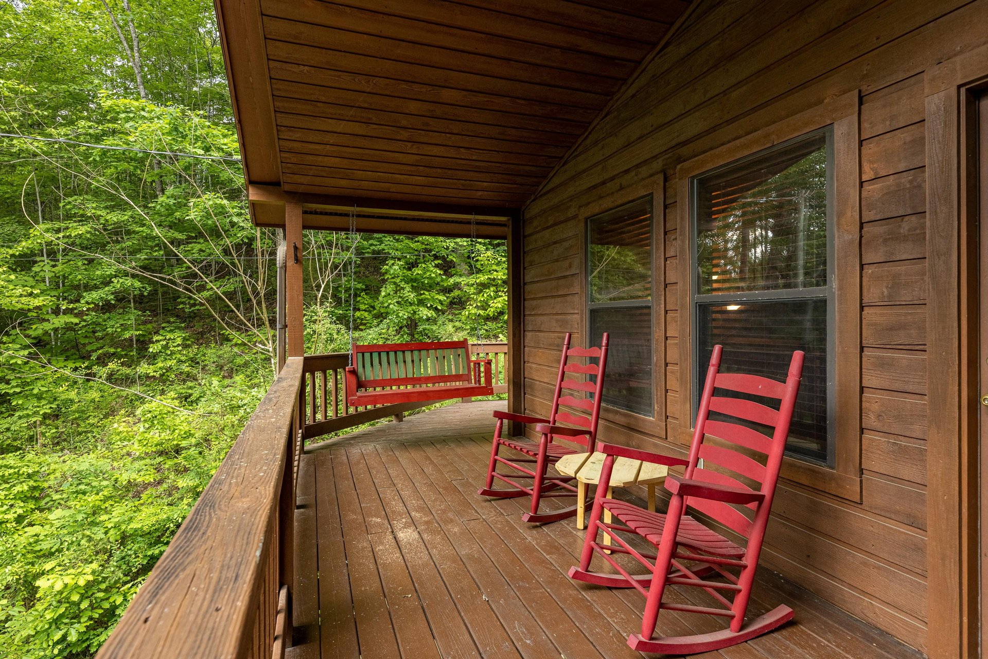 Swing and rocking chairs on a covered deck