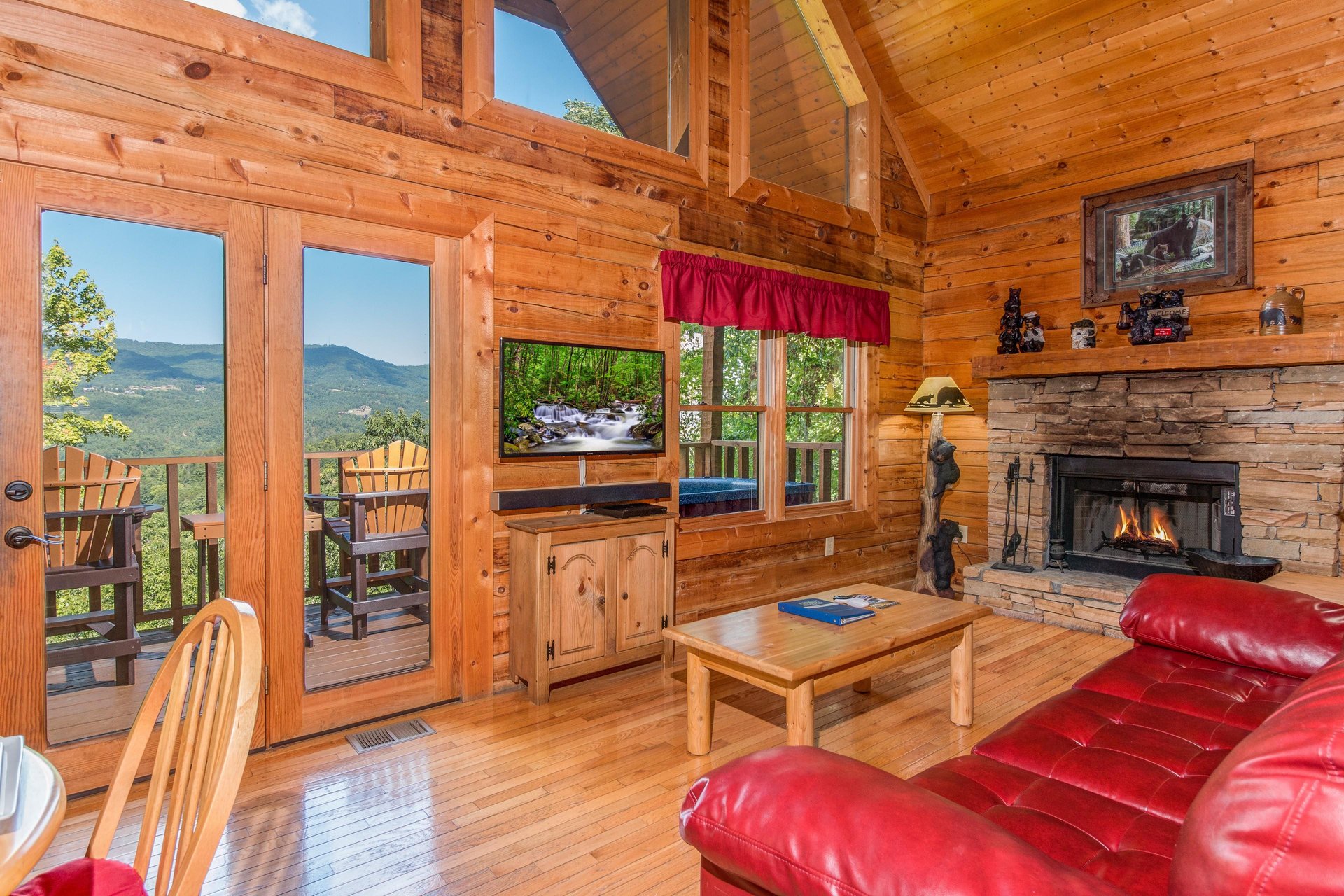 Living room with fireplace and TV at Cupids Crossing, a 1 bedroom cabin rental located in Pigeon Forge