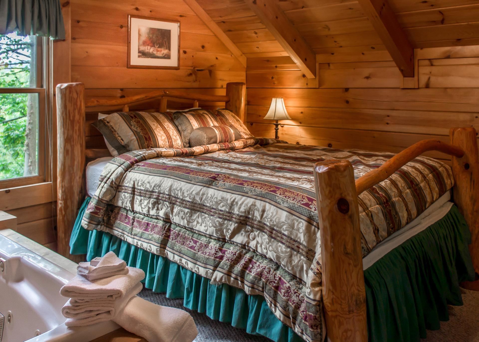 The second bedroom is located at the top of the spiral staircase and features a queen bed and soaking tub.