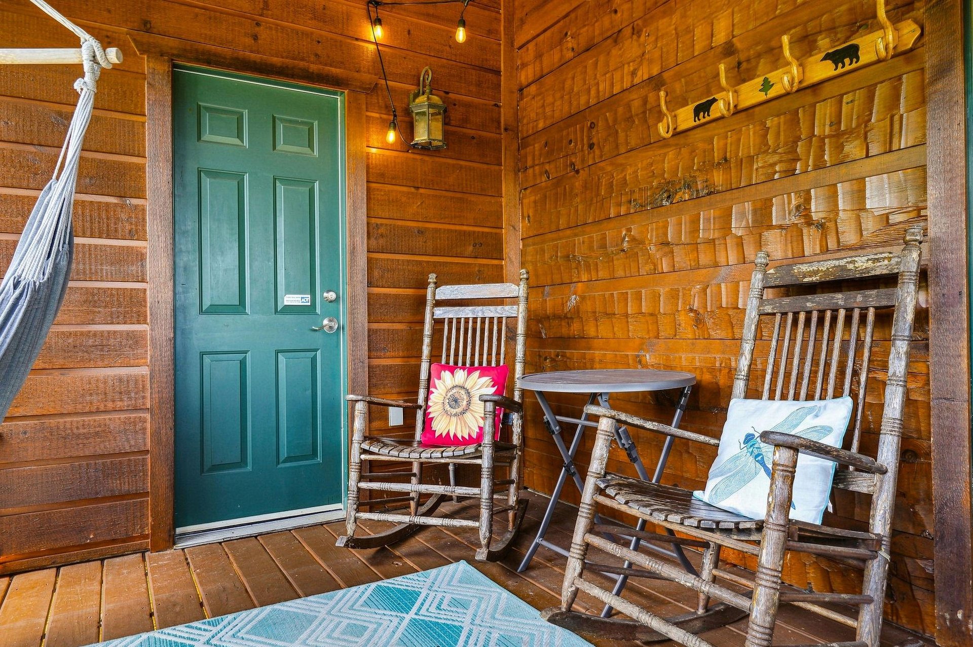 Step onto your private porch and settle into a rocking chair—the perfect place to unwind and soak in the peaceful cabin atmosphere.