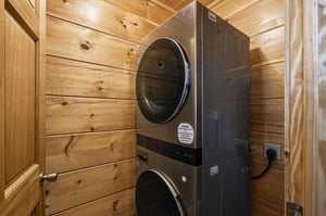 Your private laundry room features a modern washer and dryer in a cozy woodpaneled space for ultimate convenience.