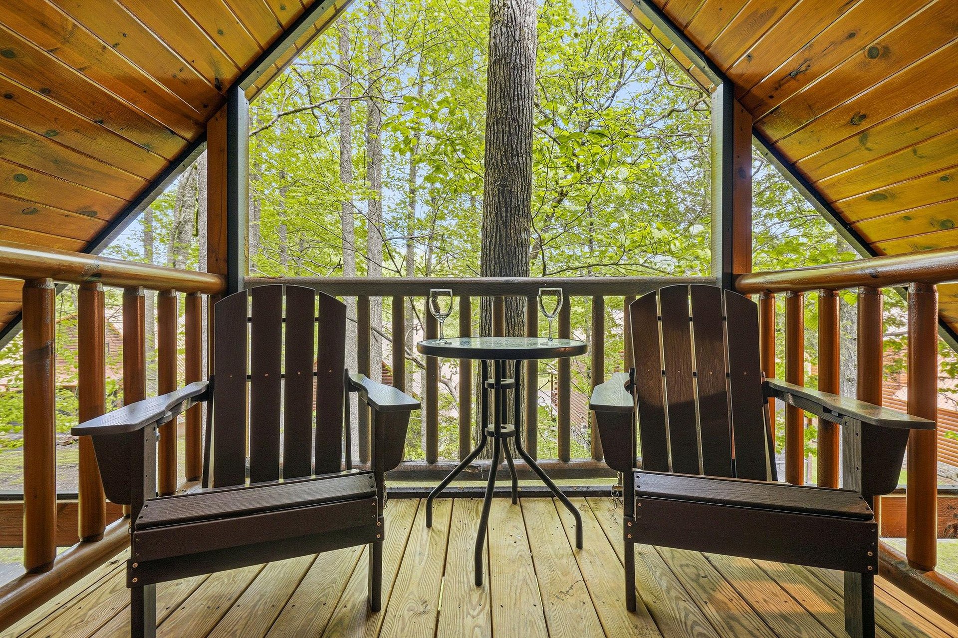 Sip your morning coffee on your private balcony surrounded by towering trees and peaceful forest views.