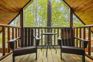 Sip your morning coffee on your private balcony surrounded by towering trees and peaceful forest views.