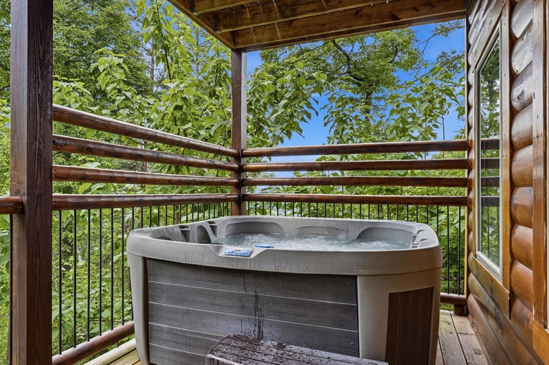 Soak beneath a canopy of vibrant greenery and blue sky in your private hot tub, where natures beauty wraps around you for pure outdoor relaxation.