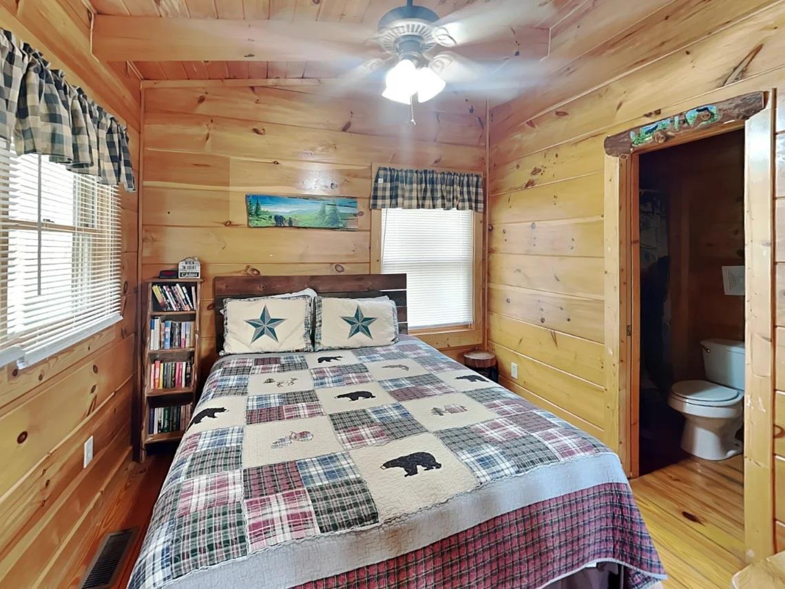 Snuggle into your cozy cabin bedroom, where warm pine walls and rustic charm invite peaceful mountain dreams. Your private space features charming woodland details and thoughtful touches for comfort.