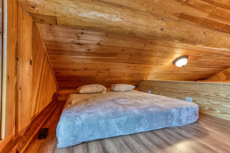 King bed in the sleeping loft off the first bedroom at Great View Lodge, a 5bedroom cabin rental located in Pigeon Forge