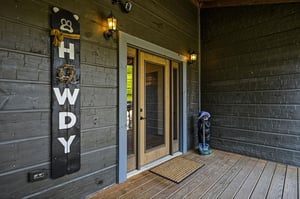 The cabins entrance features charming rustic details and warm lighting to guide your arrival.