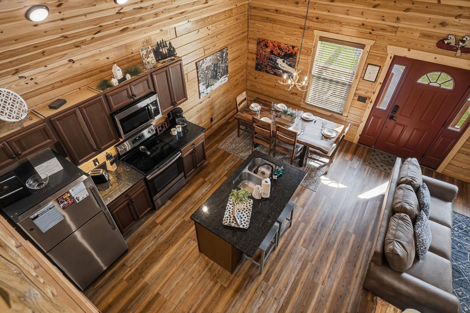 Your openconcept cabin retreat blends rustic warmth with modern comfort, where youll cook in a fullyequipped kitchen, dine together, and relax on leather sofas under soaring woodbeamed ceilings.
