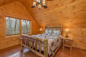 Bedroom with a log bed, two night stands, and two lamps at Js Hideaway, a 4 bedroom cabin rental located in Pigeon Forge