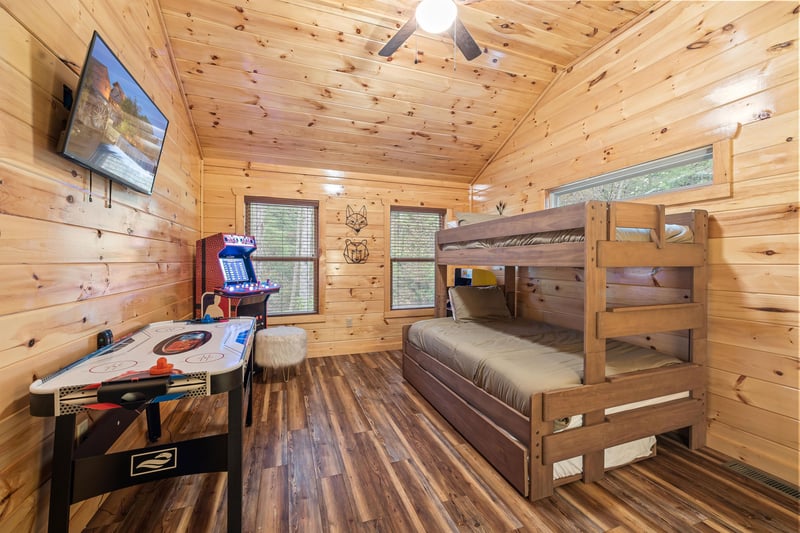 Bunk with arcade game and air hockey table