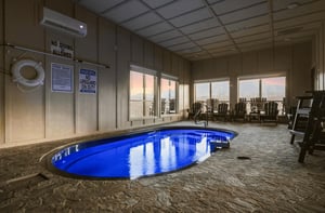 Unwind in your private indoor pool with stunning mountain views through floortoceiling windows.