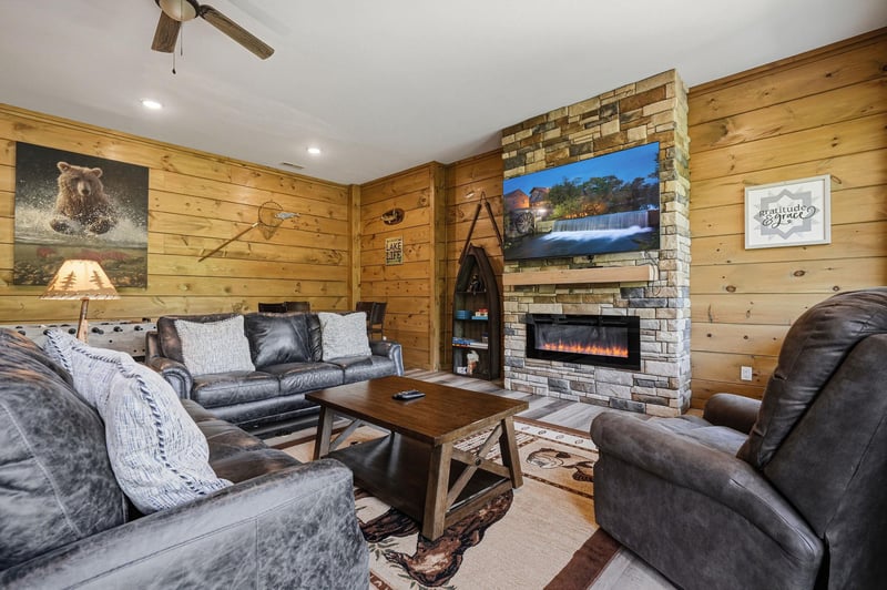 Cozy up in your rustic living room where leather seating surrounds a warm fireplace, perfect for relaxing evenings.
