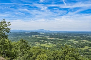 Expansive mountain vistas and rolling countryside stretch across the horizon, showcasing the scenic beauty of the surrounding natural landscape near the property.
