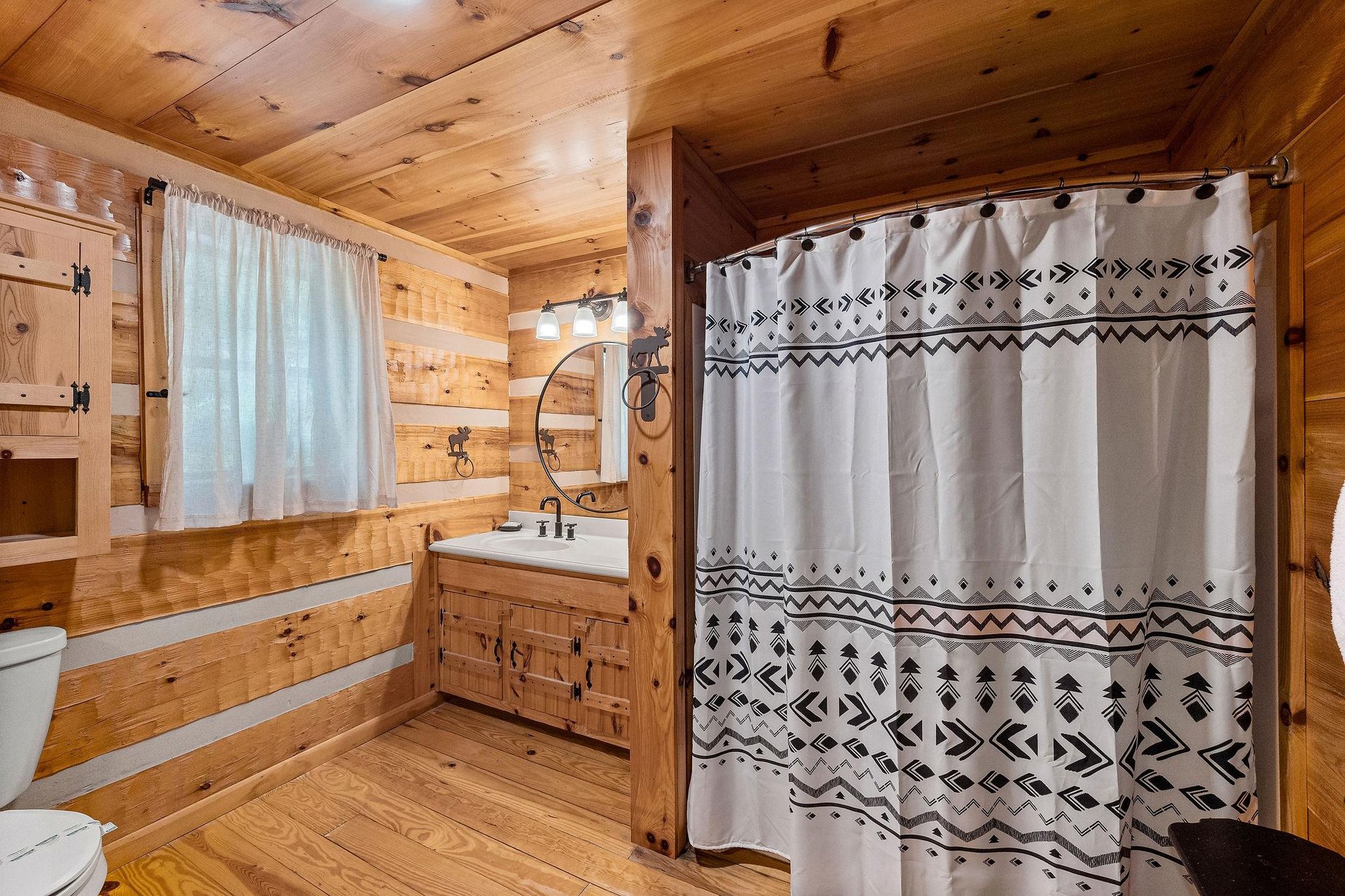 Single vanity sink with divider wall for bathtub