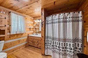 Single vanity sink with divider wall for bathtub