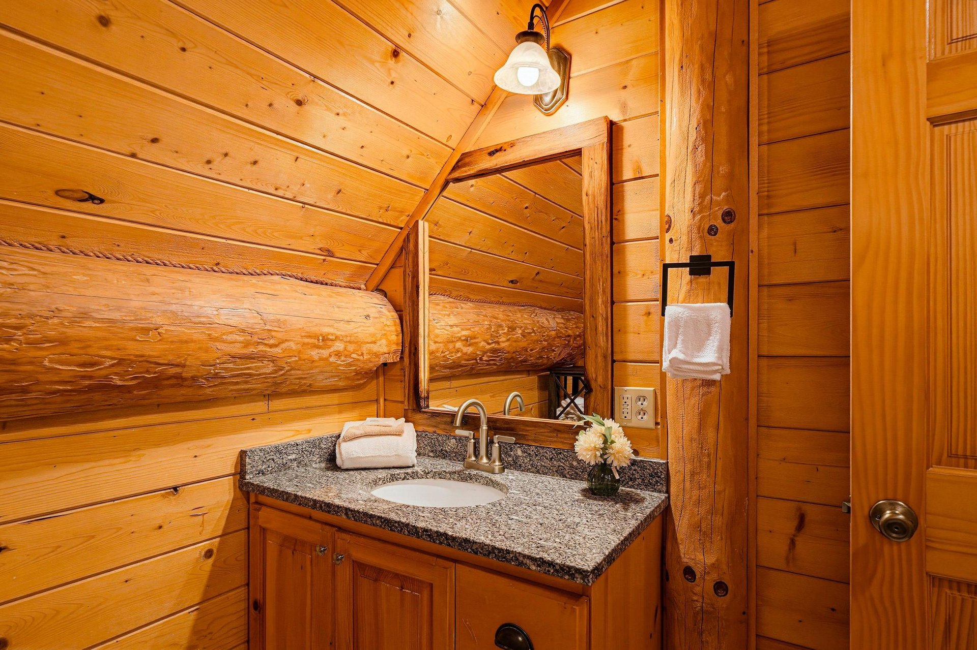 Step into your private sanctuary with rustic wood warmth surrounding you at every turn. Granite countertops and charming log accents create a cozy mountain retreat feel.