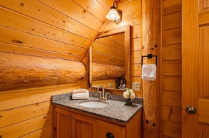 Step into your private sanctuary with rustic wood warmth surrounding you at every turn. Granite countertops and charming log accents create a cozy mountain retreat feel.