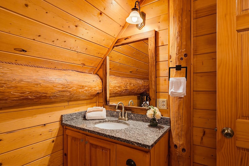 Step into your private sanctuary with rustic wood warmth surrounding you at every turn. Granite countertops and charming log accents create a cozy mountain retreat feel.