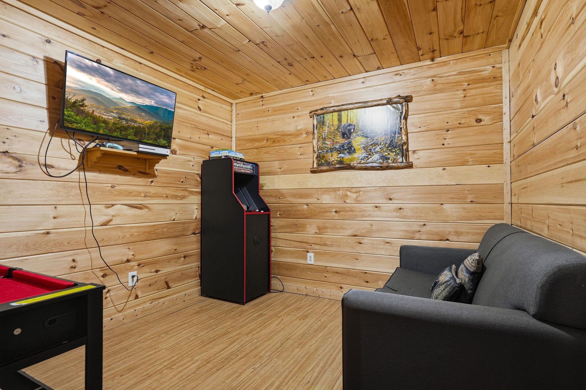 Unwind in your private game room with vintage arcade, flatscreen TV, and cozy seating—perfect for family fun or friendly competition.