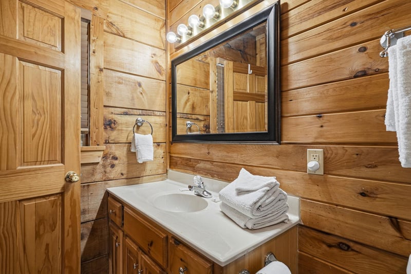 Rustic wood paneling and fresh towels create a cozy, cabinstyle retreat where you can unwind after your adventures.