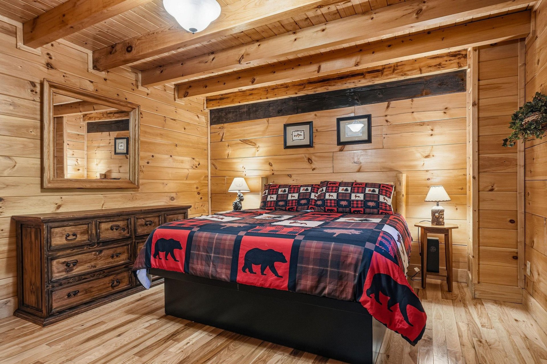 Cozy up in your rustic retreat with knotty pine walls, exposed beams, and charming bearthemed bedding that makes every night feel like a mountain escape.