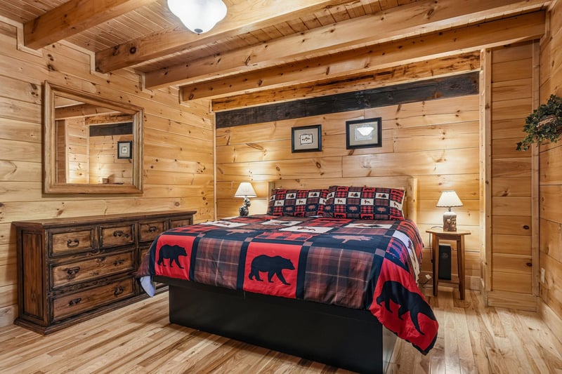 Cozy up in your rustic retreat with knotty pine walls, exposed beams, and charming bearthemed bedding that makes every night feel like a mountain escape.