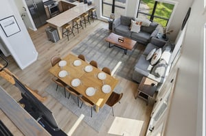Spacious openconcept living area with modern comfort, expansive dining table, and wellappointed kitchen. Floortoceiling windows flood the space with natural light.