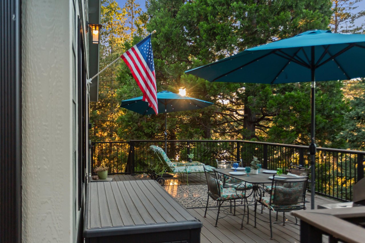 Wrap around deck with dining, lounge chairs, and BBQ.