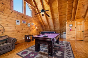 Soaring ceilings and warm wood surround your own billiard table—perfect for friendly matches beneath the exposed beams.