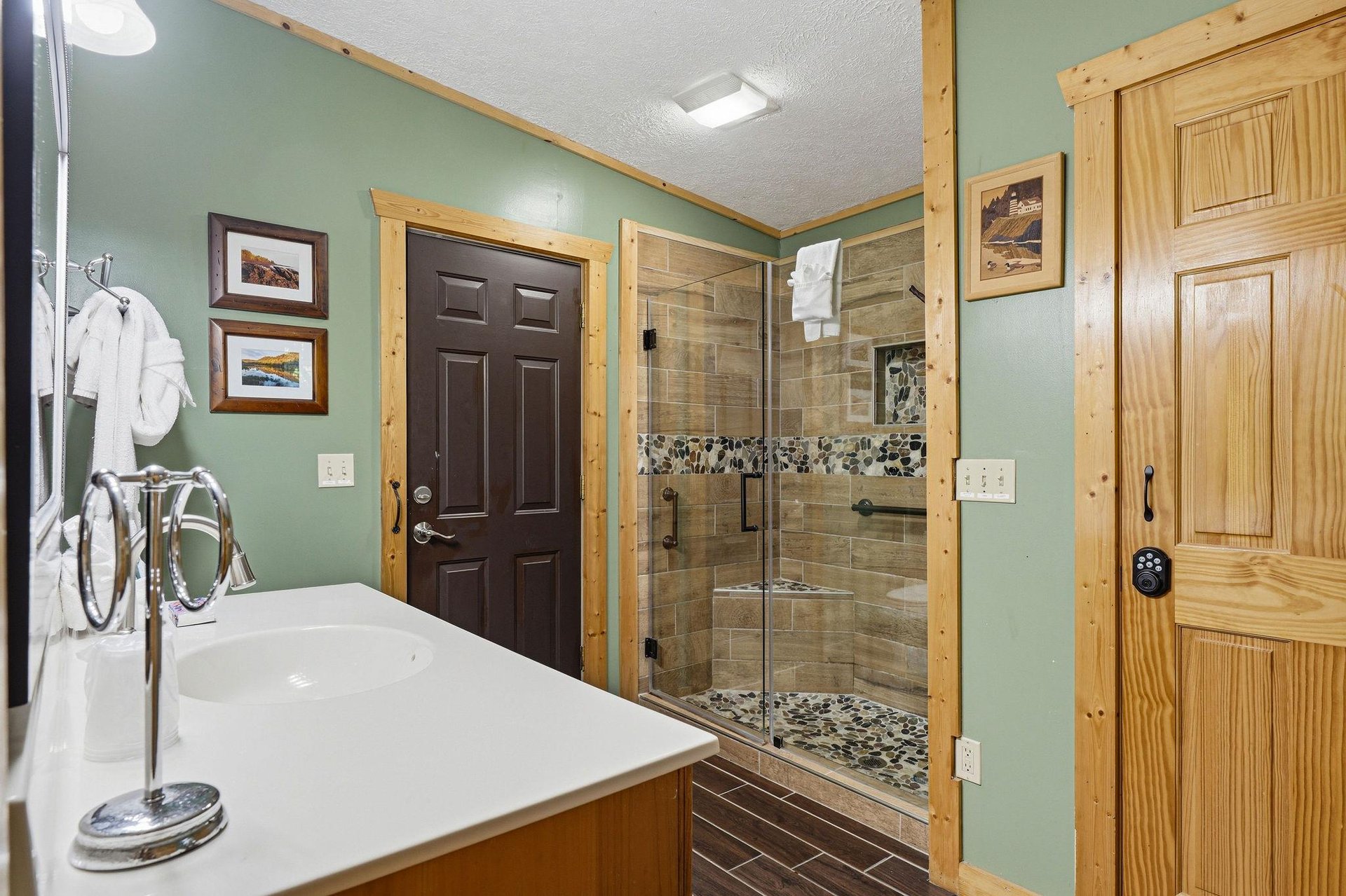 Step into your inviting bathroom with beautiful stonetiled walkin shower and plush white robes waiting for you.