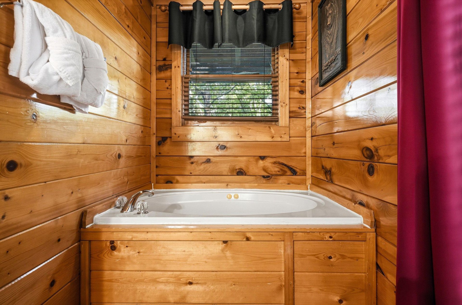 Soak away your worries in this cozy cabin tub, surrounded by warm wood and soft natural light from the window above.