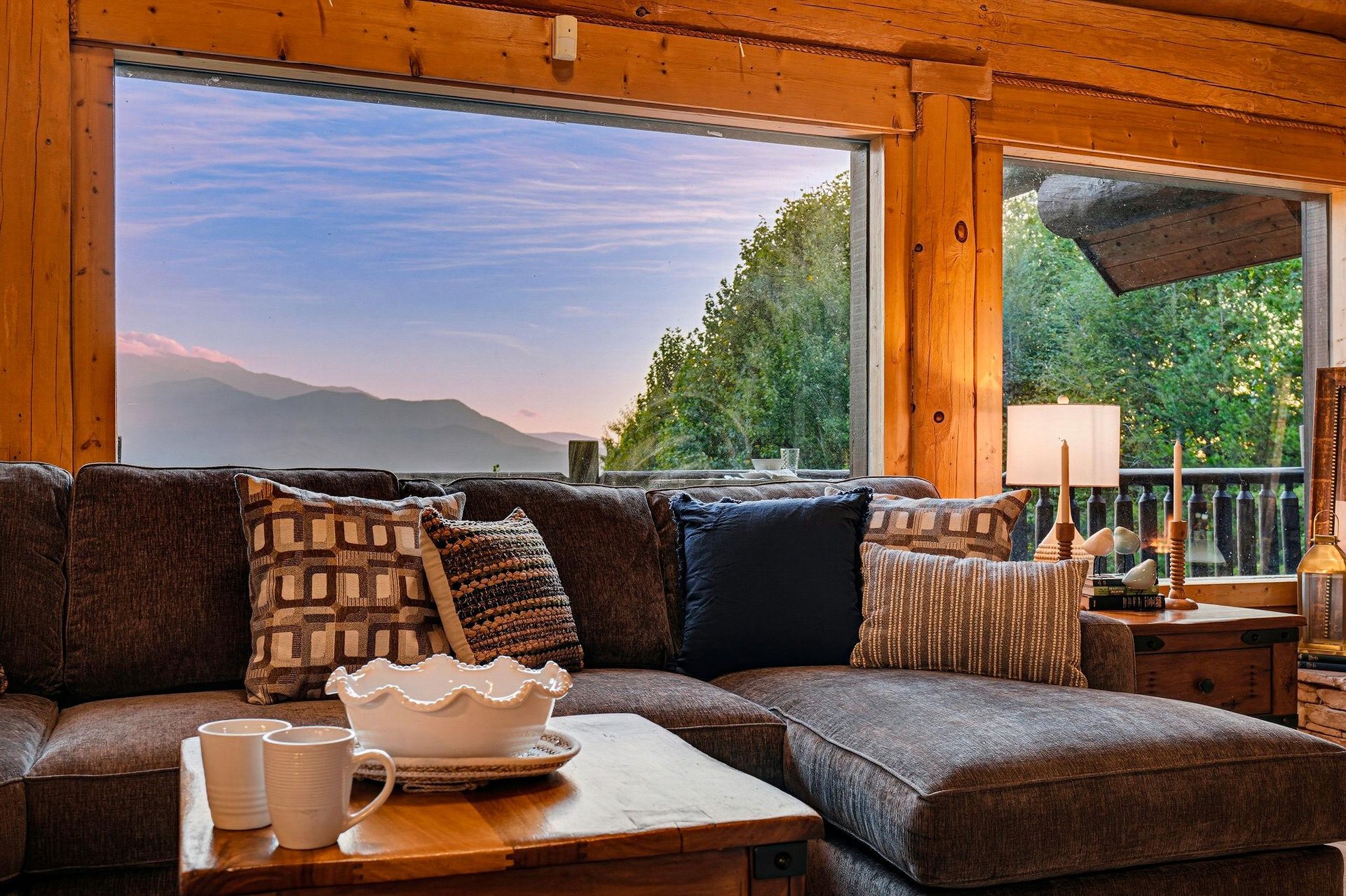 Unwind on the plush sectional as you sip your morning coffee and gaze out at the serene mountain views framed by warm woodpaneled walls.