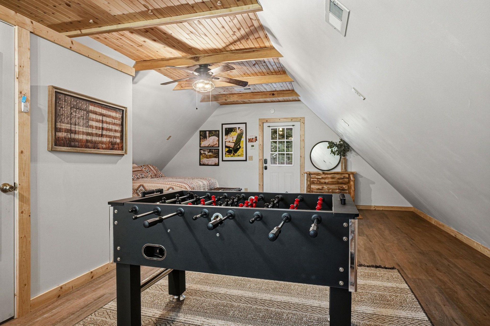 Step into your private loft game room where foosball tournaments and cozy downtime await beneath charming woodbeamed ceilings.