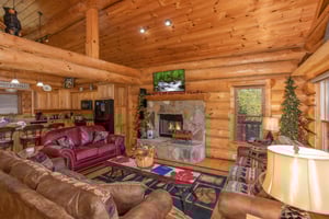 Fireplace and TV in the living room at Great View Lodge, a 5bedroom cabin rental located in Pigeon Forge