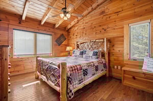 Bedroom with a wood bed at Mountain Mama, a 3 bedroom cabin rental located in Pigeon Forge