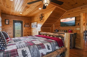 Unwind in this cozy loft bedroom where rustic log furnishings meet modern comforts. Your private sanctuary features soaring woodpaneled ceilings, a mounted TV, and mountain views that greet you at su