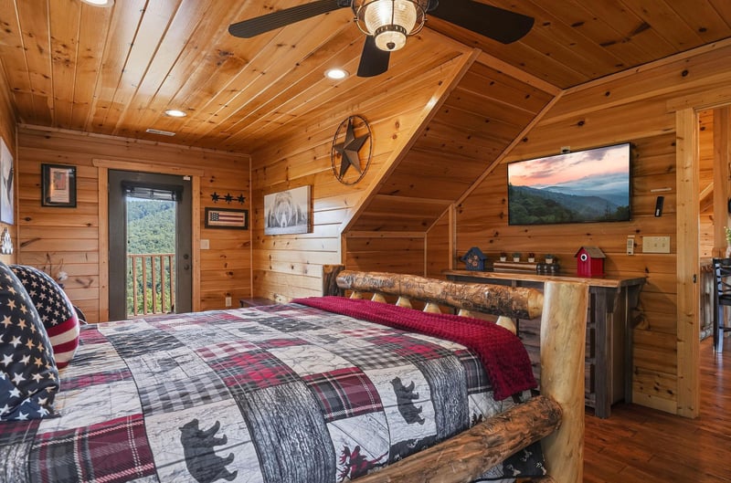 Unwind in this cozy loft bedroom where rustic log furnishings meet modern comforts. Your private sanctuary features soaring woodpaneled ceilings, a mounted TV, and mountain views that greet you at su